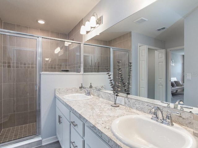 bathroom featuring vanity and a shower with door