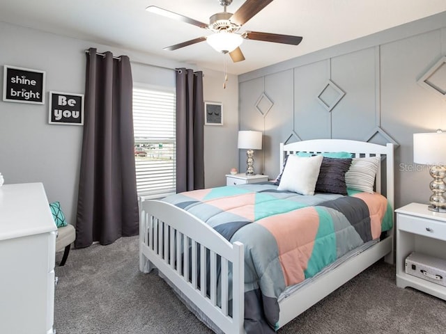 bedroom featuring ceiling fan and dark carpet