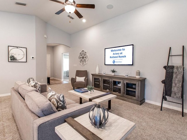 living room with ceiling fan, light carpet, and high vaulted ceiling