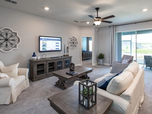 living room featuring light carpet and ceiling fan