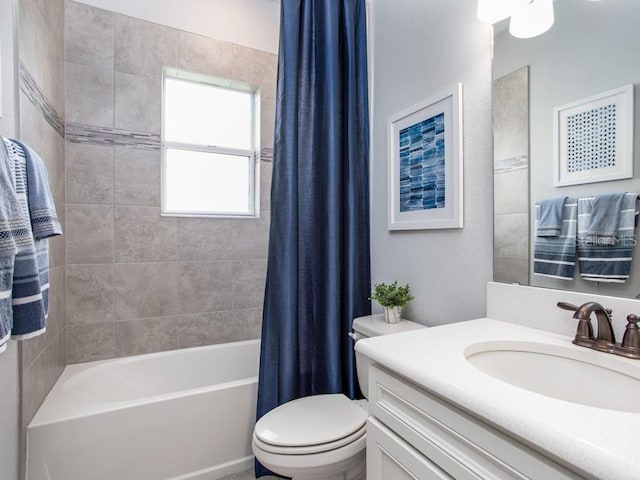 full bathroom with vanity, toilet, and shower / tub combo with curtain