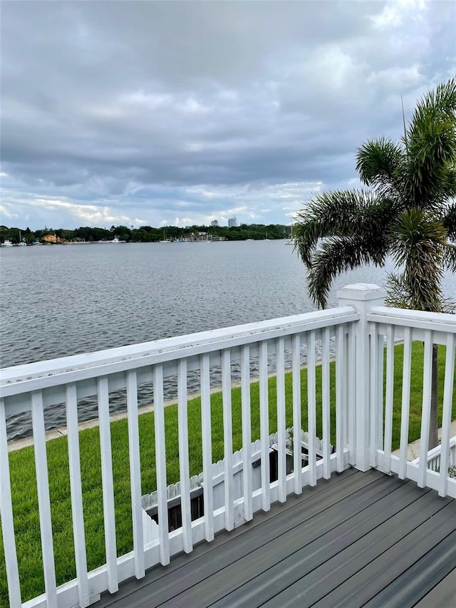 wooden terrace featuring a yard and a water view