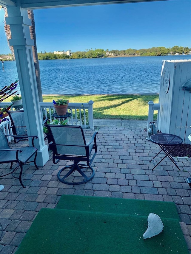 view of patio with a water view