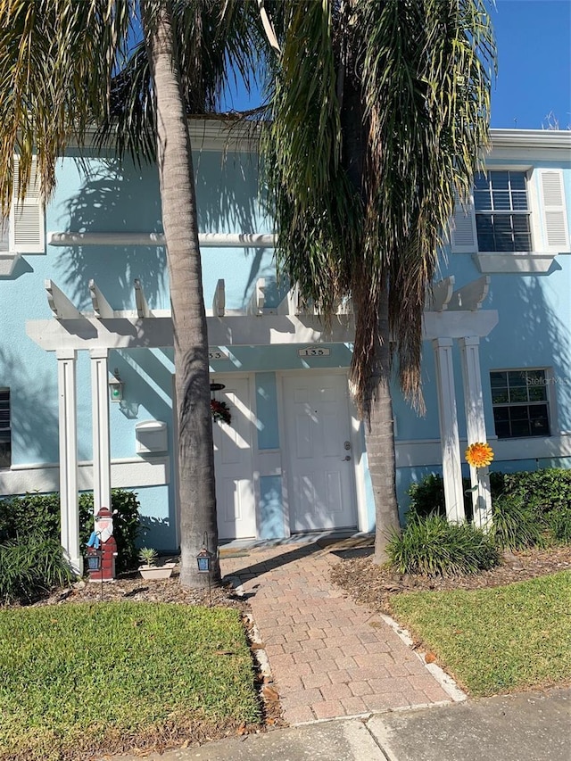 view of front of home with a pergola