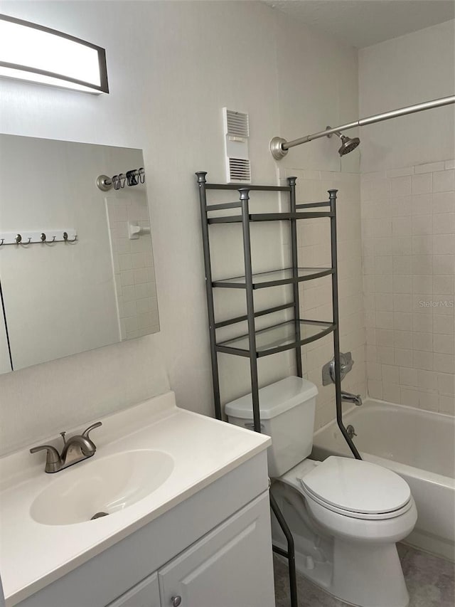 full bathroom with vanity, toilet, and tiled shower / bath