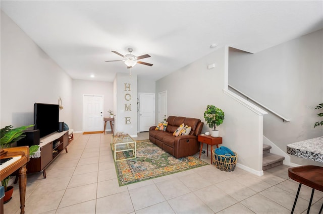 tiled living room with ceiling fan