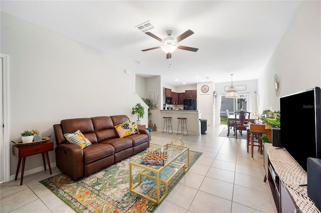 tiled living room featuring ceiling fan