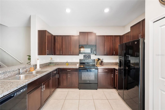 kitchen featuring light stone counters, black appliances, sink, light tile patterned flooring, and dark brown cabinets