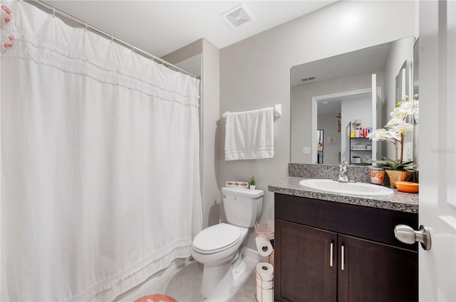 bathroom featuring tile patterned flooring, vanity, and toilet