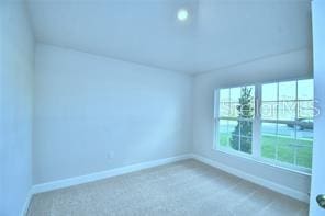 unfurnished room with carpet flooring