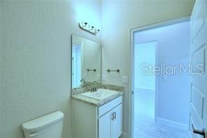 bathroom with toilet and vanity