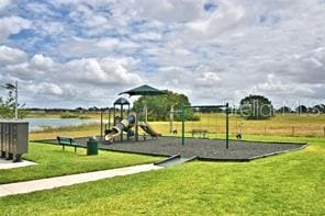 view of play area with a water view and a yard