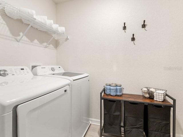 laundry area featuring hardwood / wood-style floors and washer and clothes dryer