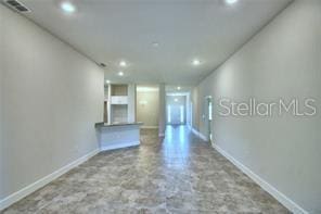 1580 Leamington Ln, Winter Haven, FL 33884 - unfurnished living room with baseboards and recessed lighting