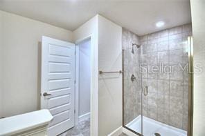 bathroom with a shower with shower door