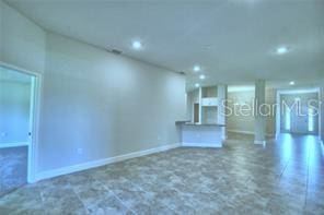 1580 Leamington Ln, Winter Haven, FL 33884 - unfurnished living room featuring recessed lighting and baseboards