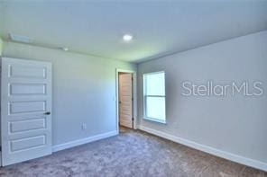 unfurnished room with carpet flooring