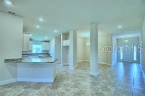 1580 Leamington Ln, Winter Haven, FL 33884 - kitchen featuring white cabinetry, a peninsula, and recessed lighting