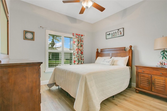 bedroom with ceiling fan and light hardwood / wood-style floors