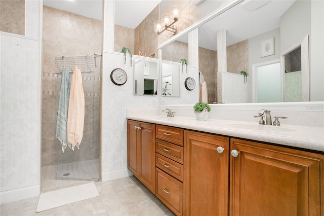 bathroom with vanity, tile patterned flooring, and a tile shower