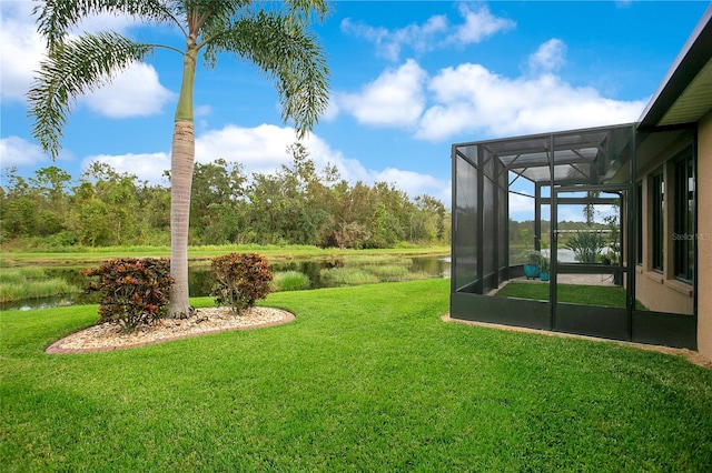 view of yard featuring a lanai and a water view