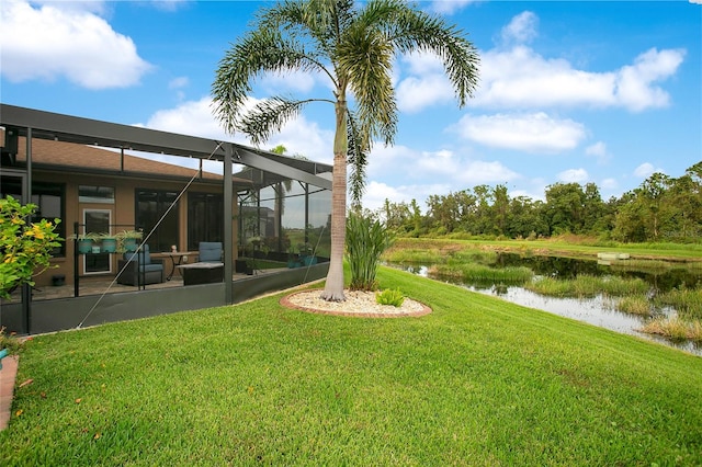 view of yard featuring a water view and a lanai