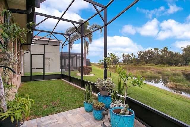 unfurnished sunroom with a water view