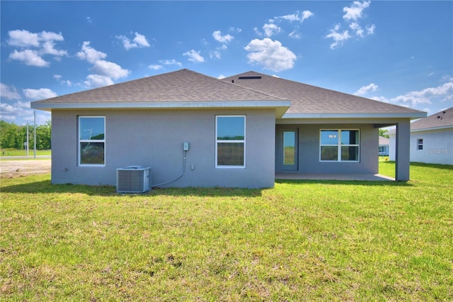 back of house featuring central AC unit, a patio, and a yard