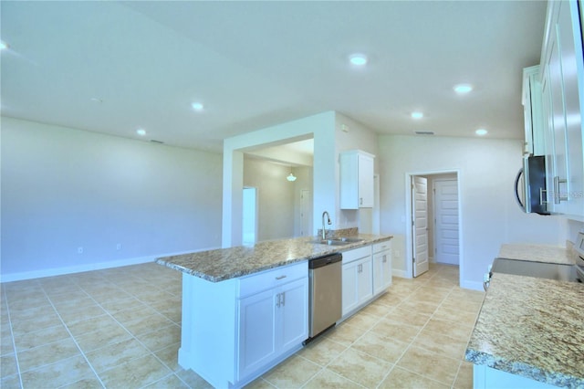 kitchen featuring stainless steel appliances, light tile patterned floors, sink, light stone countertops, and white cabinetry