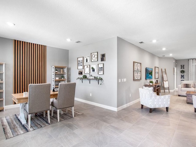 dining space featuring a textured ceiling