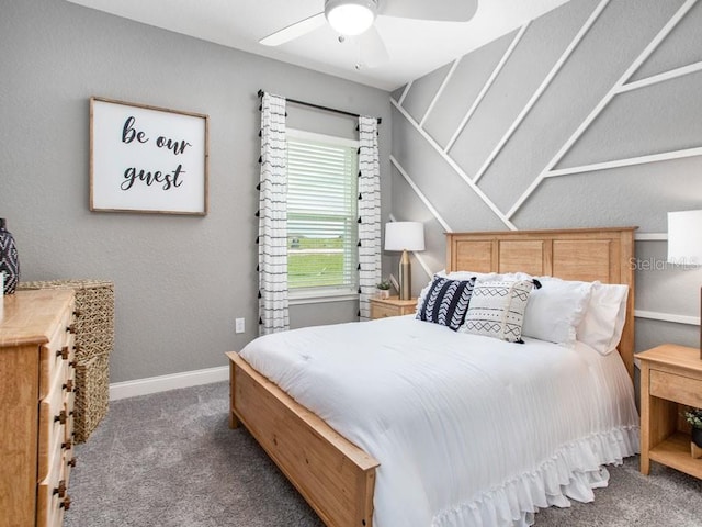 bedroom featuring ceiling fan and dark carpet