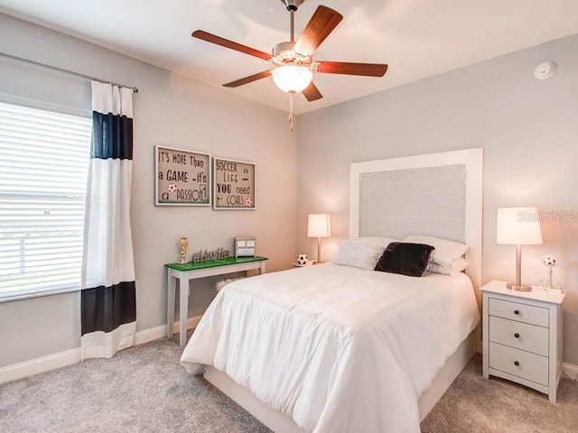 bedroom featuring light colored carpet and ceiling fan