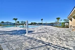 exterior space with volleyball court and a beach view