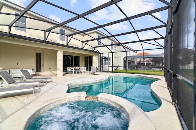 view of swimming pool with a lanai, an in ground hot tub, and a patio area