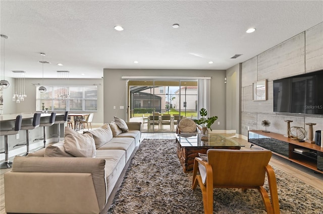 living room featuring wood-type flooring and a textured ceiling