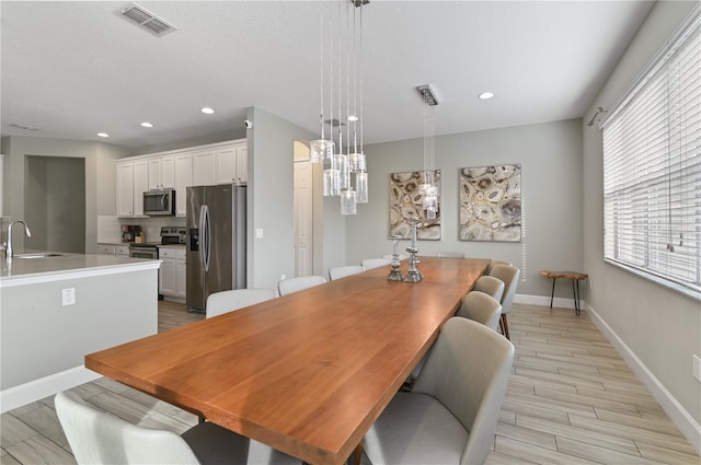 dining space featuring light hardwood / wood-style floors and sink