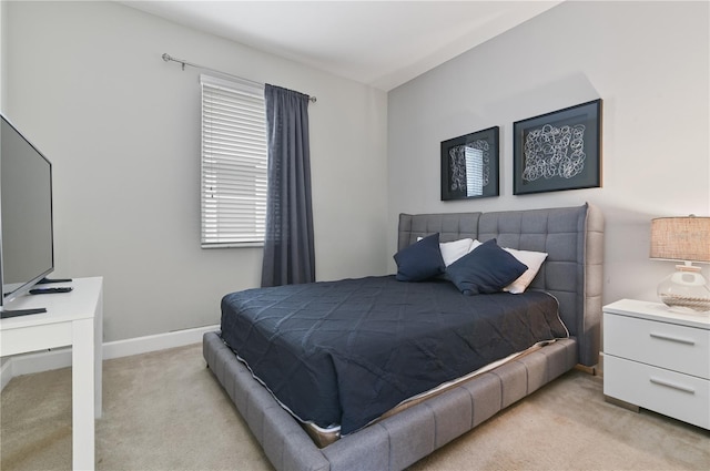 bedroom featuring light colored carpet