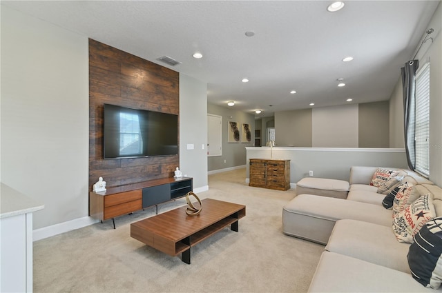 living room with wood walls and light carpet