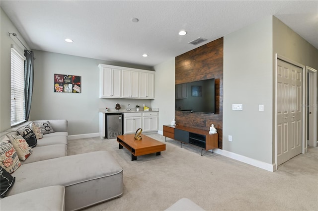 carpeted living room with a textured ceiling