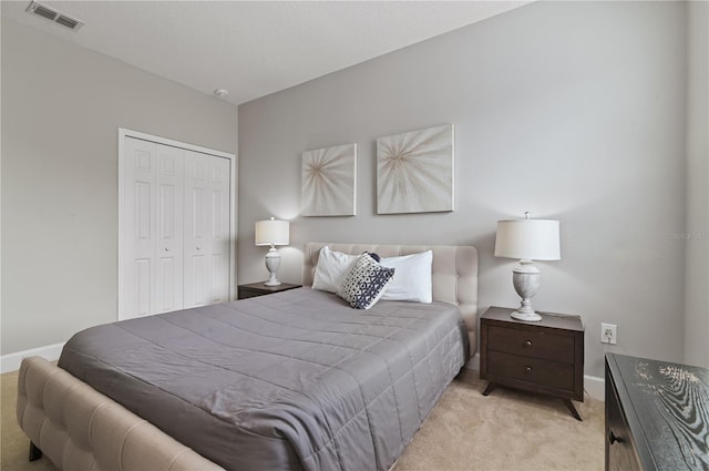 bedroom featuring light carpet and a closet