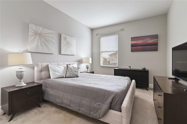 bedroom featuring light carpet