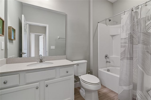 full bathroom featuring toilet, shower / tub combo, vanity, and hardwood / wood-style floors