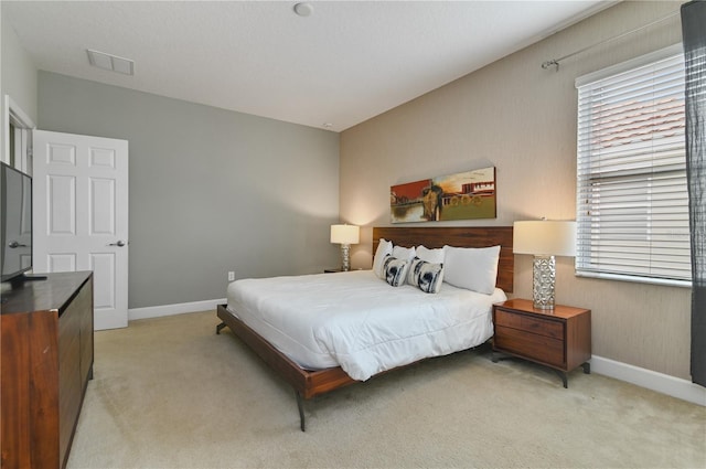 bedroom featuring light colored carpet