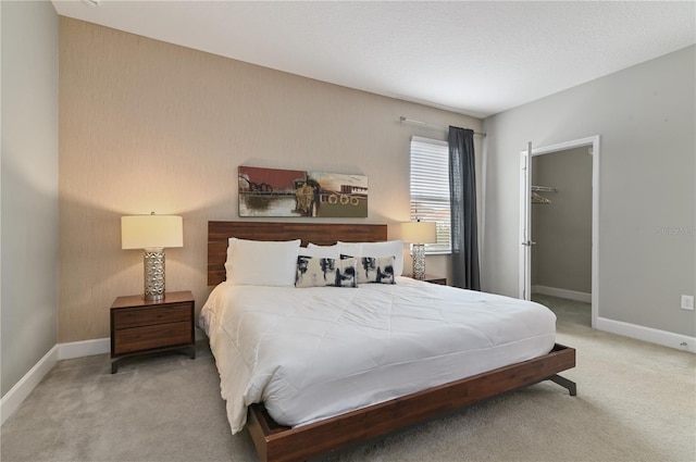 bedroom featuring carpet, a spacious closet, and a closet