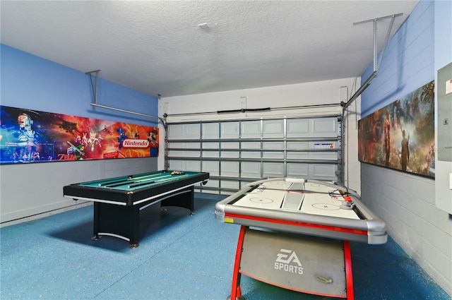 game room with a textured ceiling and pool table