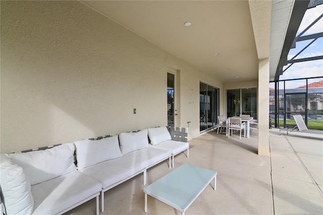 view of patio with glass enclosure and an outdoor living space