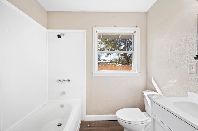 full bathroom with bathing tub / shower combination, hardwood / wood-style floors, vanity, and toilet