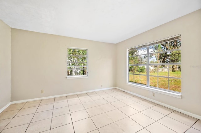 tiled empty room featuring a healthy amount of sunlight