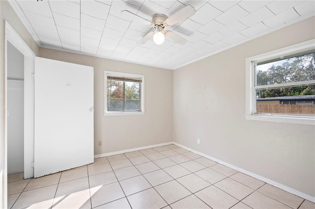 unfurnished bedroom with ornamental molding, ceiling fan, and light tile patterned flooring