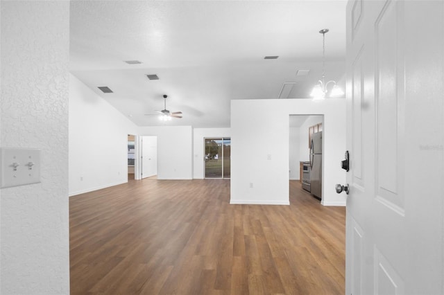 unfurnished living room with wood-type flooring and ceiling fan with notable chandelier